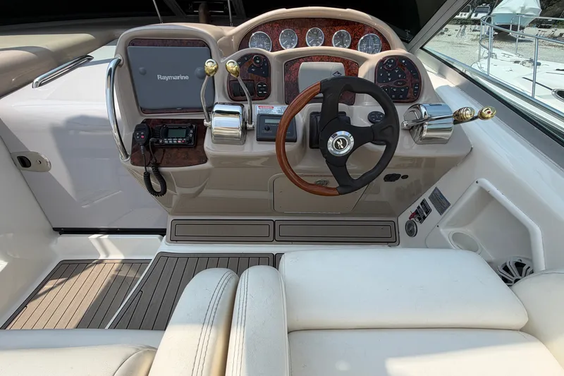 Slide: The Image of Helm of 2005 Sea Ray 340 Sundancer with Raymarine electronics and wood-accented steering wheel. - 9