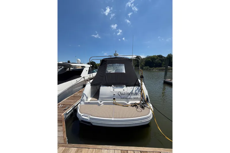 Slide: The Image of 2005 Sea Ray 340 Sundancer docked at a marina under a clear blue sky. - 2