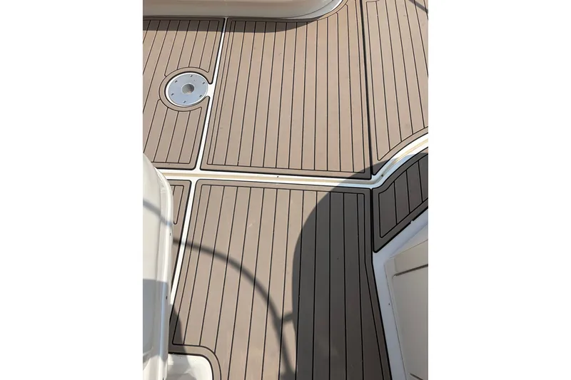 Slide: The Image of Deck of 2005 Sea Ray 340 Sundancer with wood-like finish and circular fixture. - 7