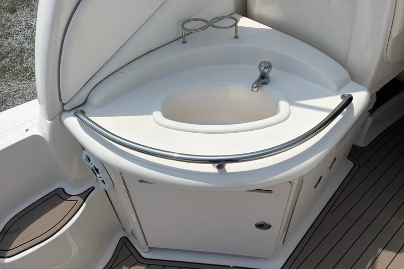 Slide: The Image of 2005 Sea Ray 340 Sundancer boat sink with faucet and storage cabinet. - 19