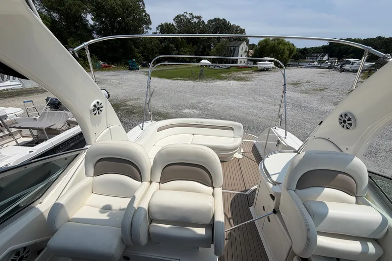 Slide: The Image of 2005 Sea Ray 340 Sundancer boat interior with plush seating and open deck view. - 8