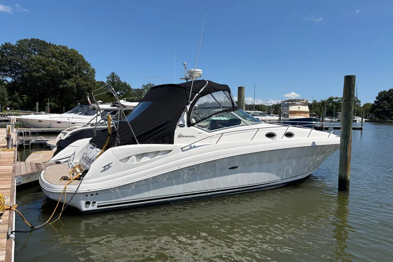 The Image of 2005 Sea Ray 340 Sundancer docked at marina under clear blue sky. - 0