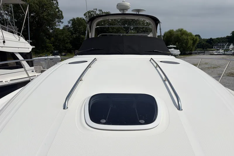 Slide: The Image of 2005 Sea Ray 340 Sundancer yacht deck with hatch, docked in a marina setting. - 4