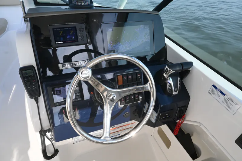 Slide: The Image of Helm of 2021 Pursuit DC 266 Dual Console with steering wheel and navigation displays. - 21
