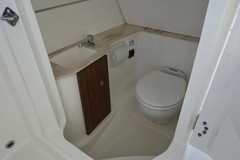 Slide: The Image of 2021 Pursuit DC 266 Dual Console boat bathroom with sink and toilet. - 24