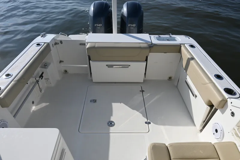 Slide: The Image of 2021 Pursuit DC 266 Dual Console boat interior with seating and twin engines. - 27