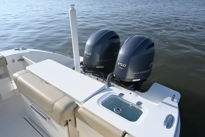 Slide: The Image of 2021 Pursuit DC 266 Dual Console boat with twin Yamaha 150 engines on calm water. - 29