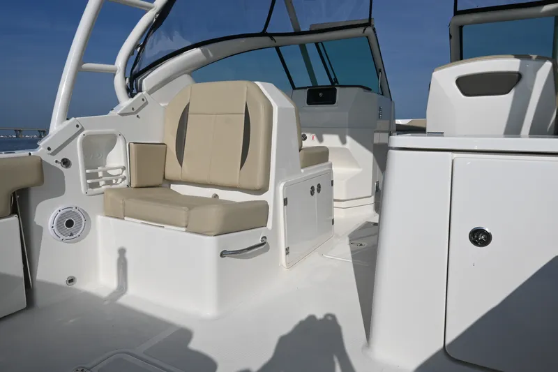 Slide: The Image of 2021 Pursuit DC 266 Dual Console boat interior with beige seating and modern design. - 25