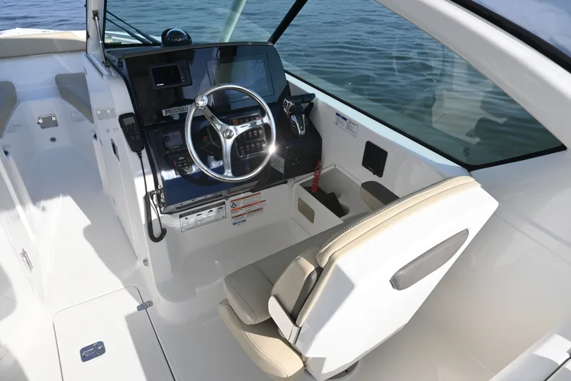 Slide: The Image of 2021 Pursuit DC 266 Dual Console boat interior with steering wheel and seating. - 20