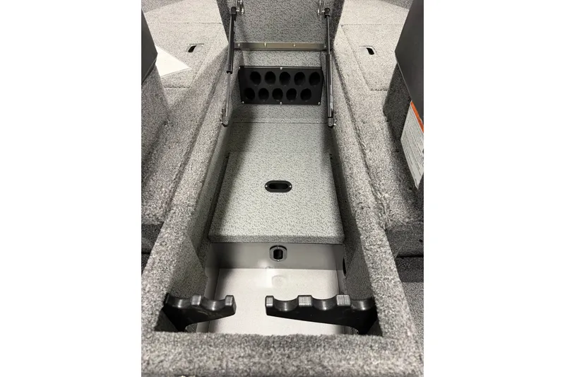 Slide: The Image of 2026 Crestliner 1750 Hawk WT boat interior storage compartment with rod holders. - 14