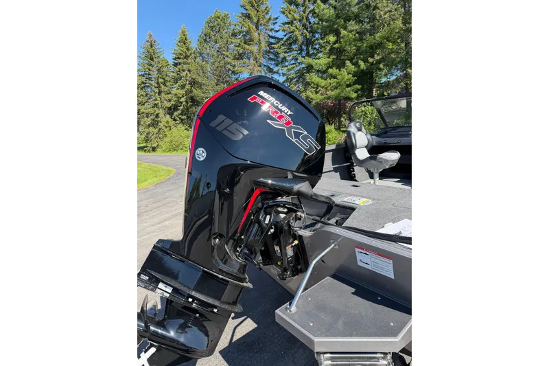 Slide: The Image of 2026 Crestliner 1750 Hawk WT with Mercury Pro XS 115 outboard motor, parked outdoors. - 20