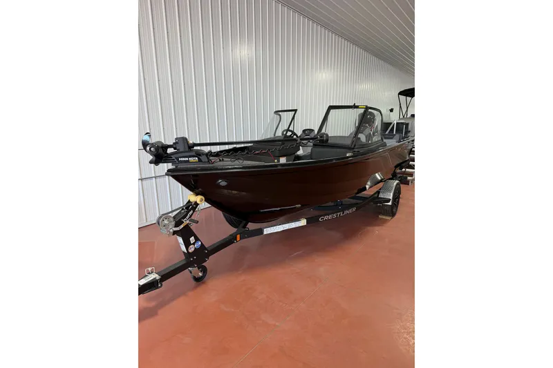 Slide: The Image of 2026 Crestliner 1750 Hawk WT boat on trailer in indoor showroom. - 0