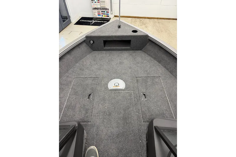 Slide: The Image of 2026 Crestliner 1750 Hawk WT boat interior with carpeted deck and storage compartments. - 15