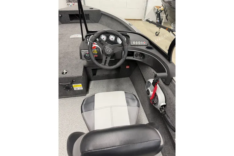 Slide: The Image of 2026 Crestliner 1750 Hawk WT boat interior with steering wheel and dashboard controls. - 2