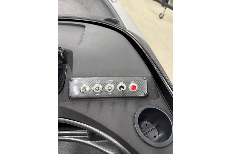 Slide: The Image of Control panel of 2026 Crestliner 1750 Hawk WT boat with switches and cup holder. - 10