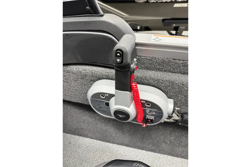 Slide: The Image of Control panel of 2026 Crestliner 1750 Hawk WT boat with throttle lever and safety cord. - 12