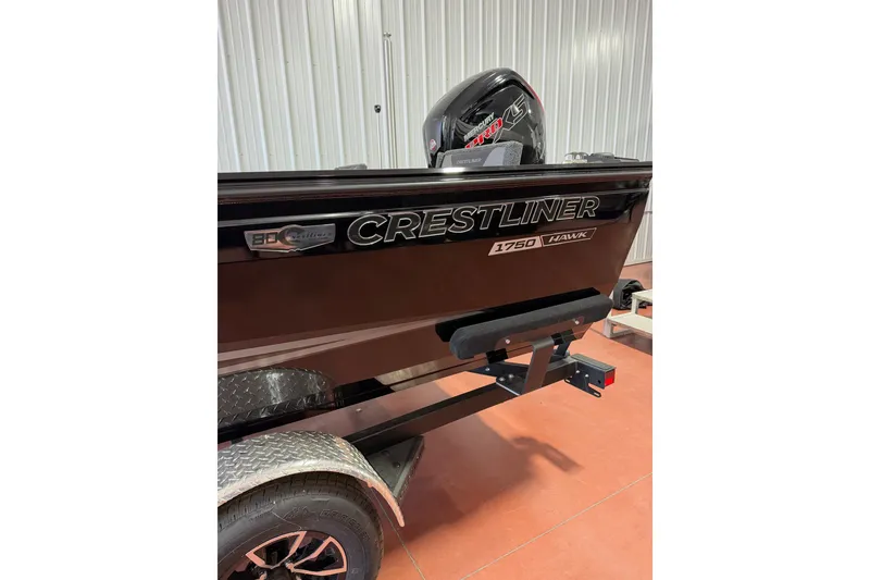 Slide: The Image of 2026 Crestliner 1750 Hawk WT boat on trailer in garage setting. - 5