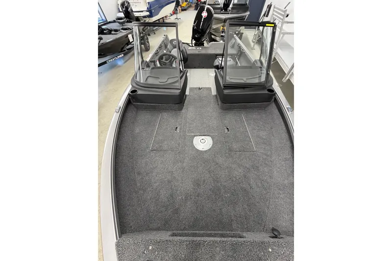 Slide: The Image of 2026 Crestliner 1750 Hawk WT boat interior with dual windshields and spacious carpeted deck. - 18