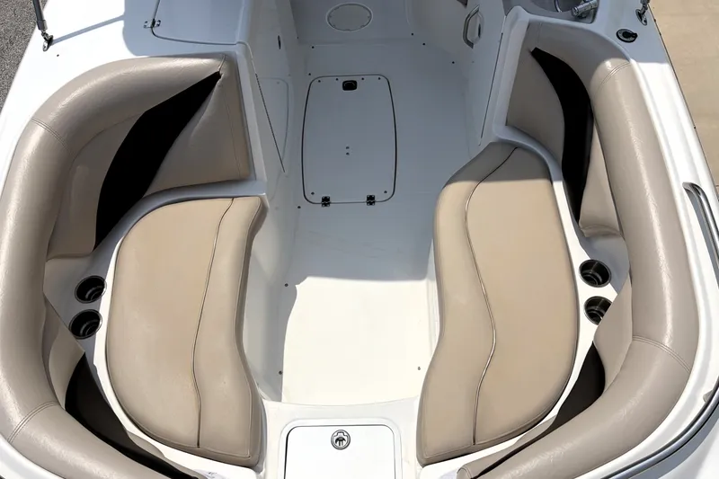 Slide: The Image of 2012 Hurricane SunDeck Sport 220 OB boat interior with beige seating and cup holders. - 25