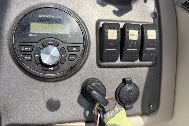 Slide: The Image of Control panel of a 2012 Hurricane SunDeck Sport 220 OB with stereo and accessory switches. - 38