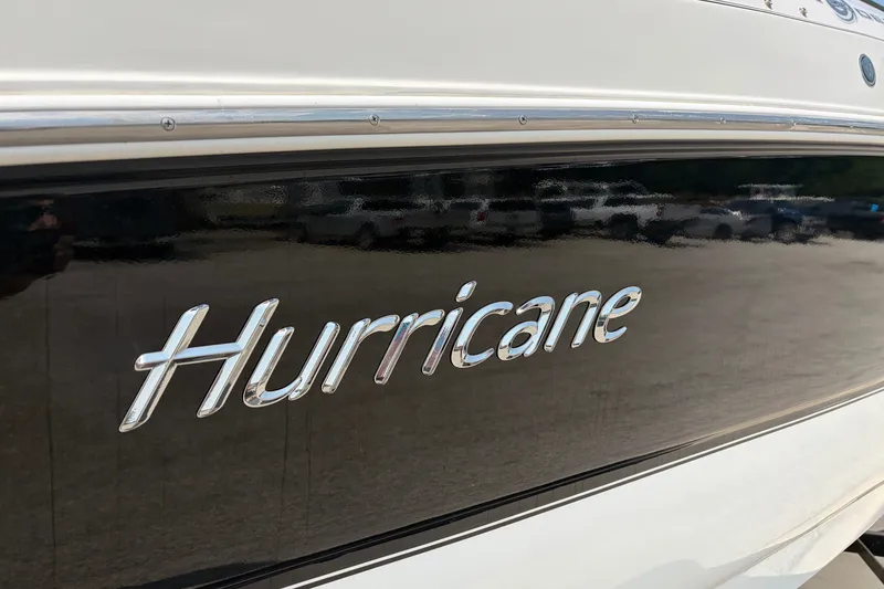 Slide: The Image of 2012 Hurricane SunDeck Sport 220 OB boat with sleek black and white design. - 18