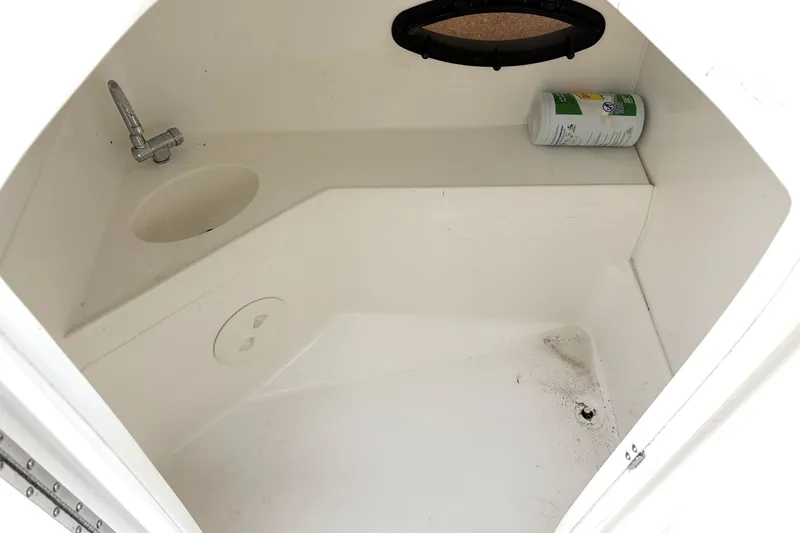 Slide: The Image of Interior of 2012 Hurricane SunDeck Sport 220 OB boat with sink and storage space. - 30
