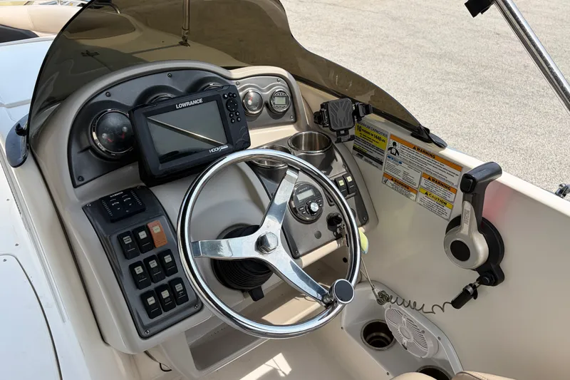 Slide: The Image of Cockpit of 2012 Hurricane SunDeck Sport 220 OB with steering wheel and navigation system. - 35
