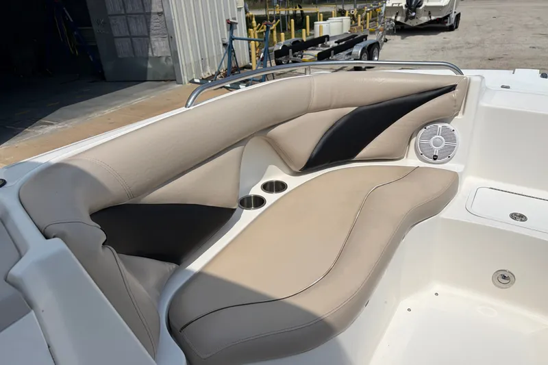 Slide: The Image of 2012 Hurricane SunDeck Sport 220 OB boat interior with beige seating and cup holders. - 26