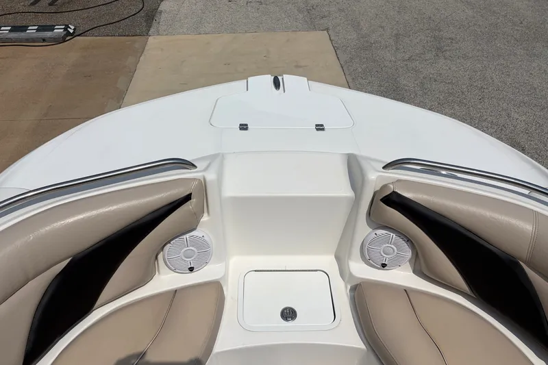 Slide: The Image of 2012 Hurricane SunDeck Sport 220 OB boat interior with beige seating and speakers. - 23