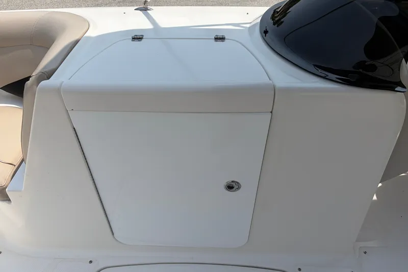 Slide: The Image of 2012 Hurricane SunDeck Sport 220 OB boat console with storage compartment and seating. - 29
