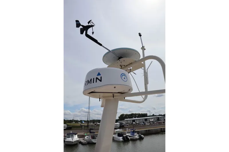 Slide: The Image of Radar and weather vane on 2004 Mainship 390 Trawler, docked at marina. - 8