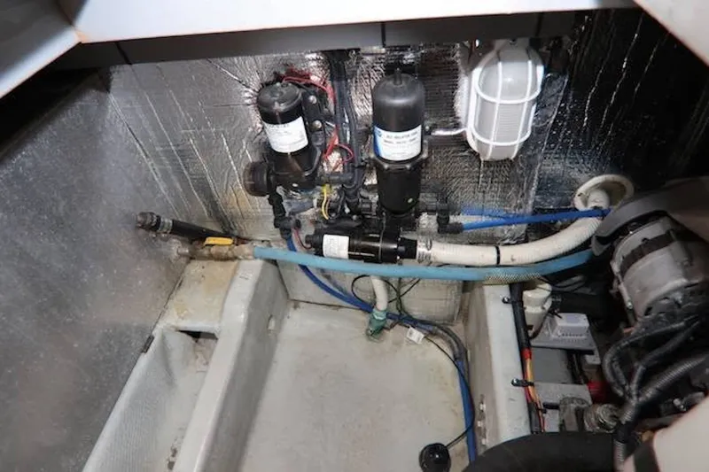 Slide: The Image of Engine room of 2004 Mainship 390 Trawler with visible mechanical components and wiring. - 23