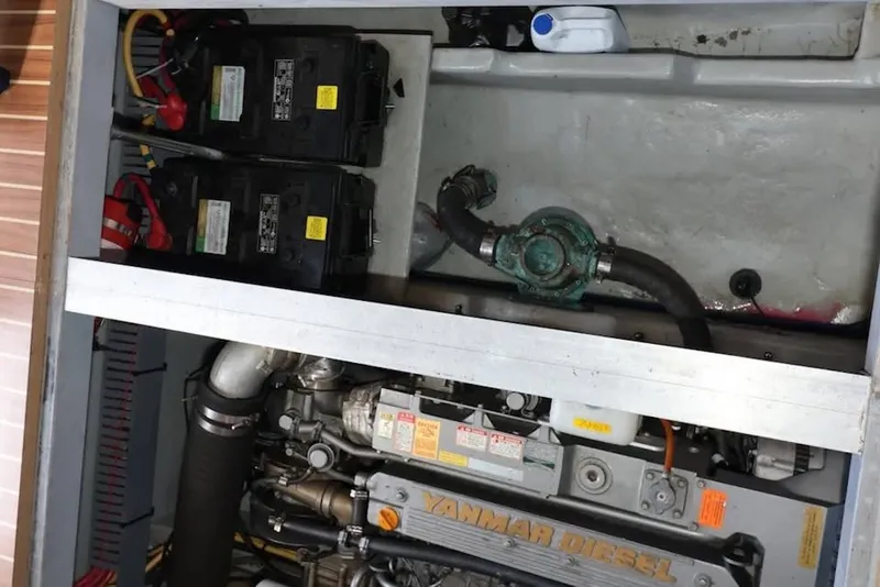 Slide: The Image of Engine compartment of 2004 Mainship 390 Trawler with Yanmar diesel engine and batteries. - 24