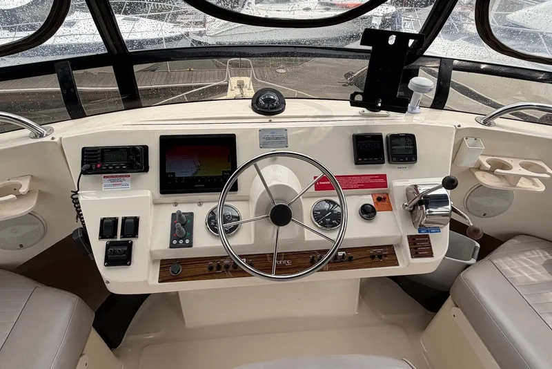 Slide: The Image of Helm of 2004 Mainship 390 Trawler with navigation instruments and steering wheel. - 2
