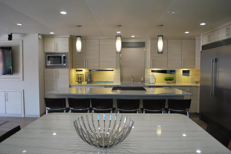 Slide: The Image of Modern kitchen interior with sleek design, featuring stainless steel appliances and elegant lighting. - 10