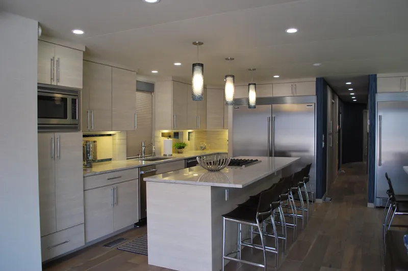Slide: The Image of Modern kitchen interior with sleek cabinetry, island seating, and stainless steel appliances, Adonia Azul Trip 2017. - 8
