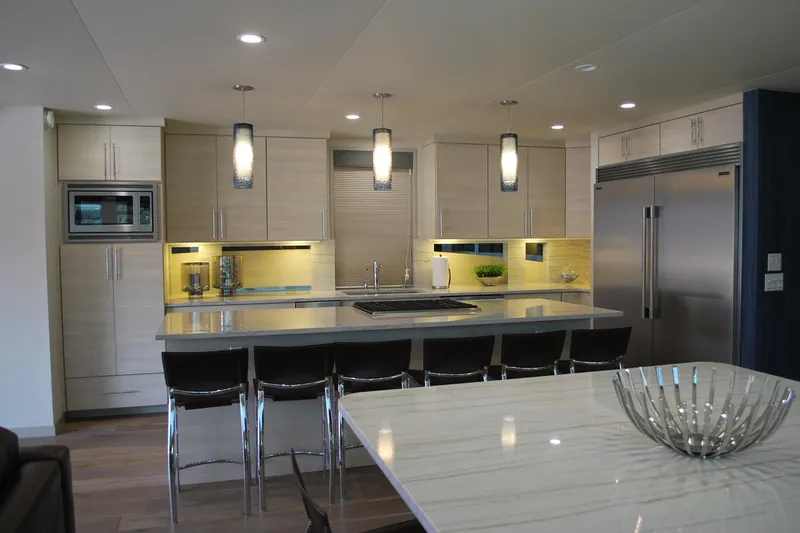 Slide: The Image of Modern kitchen with sleek cabinetry, island seating, pendant lighting, and stainless steel appliances, 2017 Adonia Azul Trip. - 9