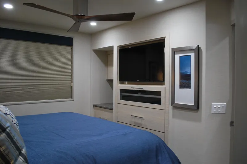 Slide: The Image of Modern bedroom with blue bedding, wall-mounted TV, and framed artwork, Adonia Azul Trip 2017. - 18