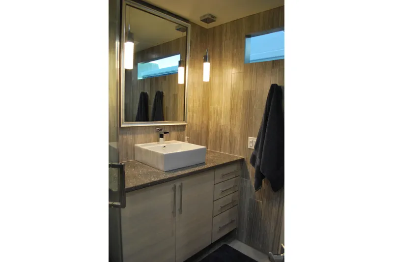 Slide: The Image of Modern bathroom with vessel sink, wood paneling, and sleek lighting fixtures. Adonia Azul Trip 2017. - 20