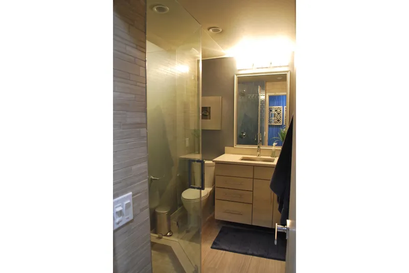 Slide: The Image of Modern bathroom with glass shower, wooden cabinets, and bright lighting, Adonia Azul Trip 2017. - 13