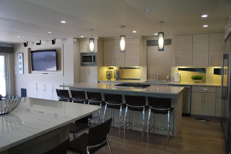 Slide: The Image of Modern kitchen with island, bar stools, pendant lights, and sleek cabinetry, from Adonia Azul Trip 2017. - 11