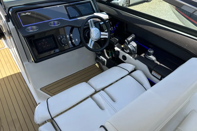Slide: The Image of 2018 Sea Ray SLX 310 Outboard cockpit with modern controls and luxurious seating. - 35