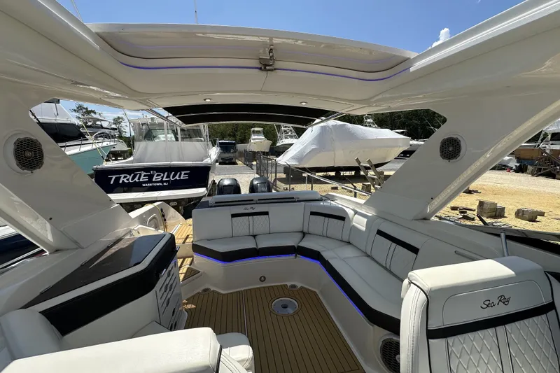Slide: The Image of Luxurious 2018 Sea Ray SLX 310 Outboard boat interior with spacious seating and sleek design. - 4