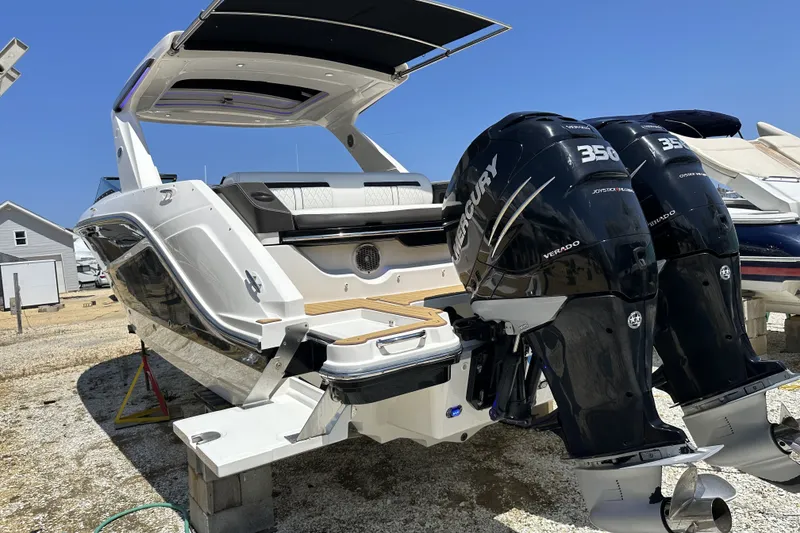 Slide: The Image of 2018 Sea Ray SLX 310 Outboard with twin Mercury 350 engines, docked on land. - 36