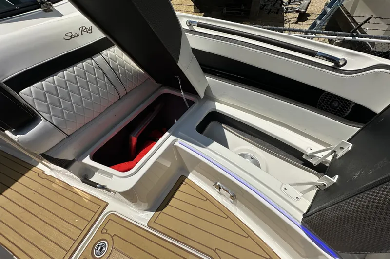 Slide: The Image of 2018 Sea Ray SLX 310 Outboard boat interior with open storage compartments. - 17