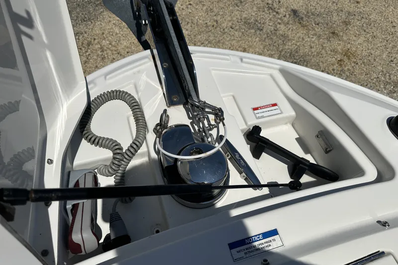 Slide: The Image of Anchor compartment of 2018 Sea Ray SLX 310 Outboard boat with coiled rope and equipment. - 13