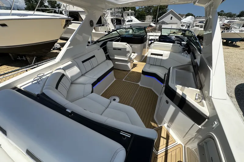 Slide: The Image of Luxurious 2018 Sea Ray SLX 310 Outboard boat interior with spacious seating and modern design. - 28