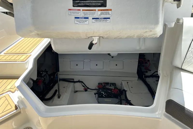 Slide: The Image of Open engine compartment of 2018 Sea Ray SLX 310 Outboard boat, showing battery and wiring. - 7
