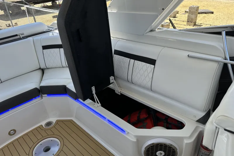 Slide: The Image of 2018 Sea Ray SLX 310 Outboard boat interior with open storage compartment and seating. - 33