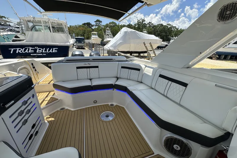 Slide: The Image of Luxurious seating on 2018 Sea Ray SLX 310 Outboard boat, featuring elegant design and ambient lighting. - 6